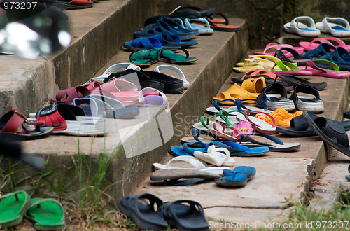 Image of Plastic sandals on concrete stairs