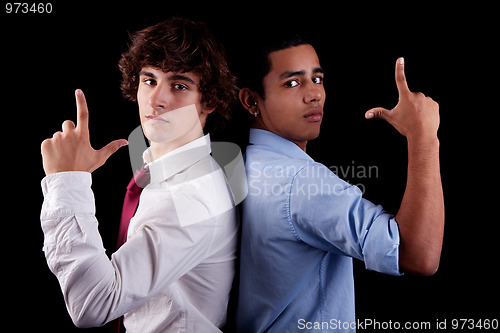 Image of two young man of different colors, back to back, with hand as an police officer with weapon raised