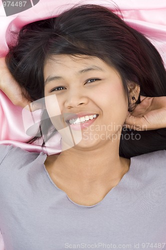 Image of beautiful woman on pink silk