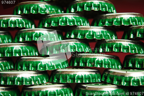 Image of pile of green beer caps