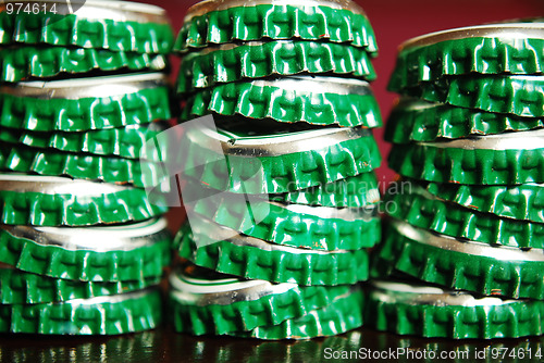 Image of pile of green beer caps