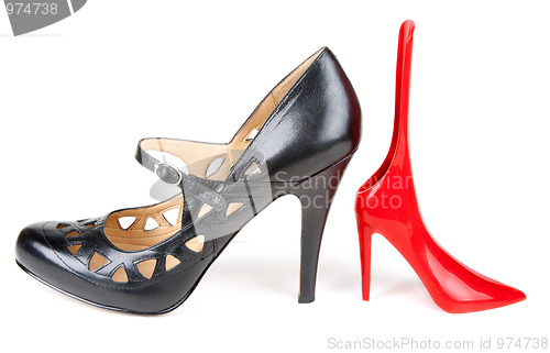 Image of Black feminine loafer and red shoehorn