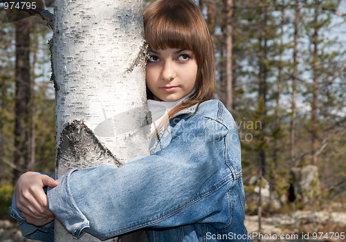 Image of Young beautiful girl and birch