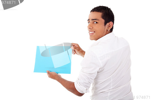 Image of young latin man, from back, with blue  card in hand, smiling