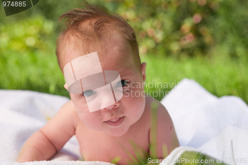 Image of baby laying in the grass 