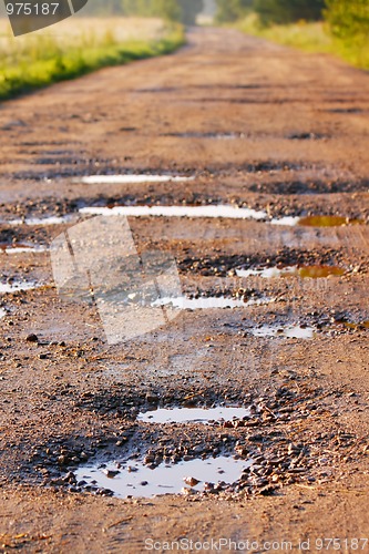 Image of Red clay road with holes