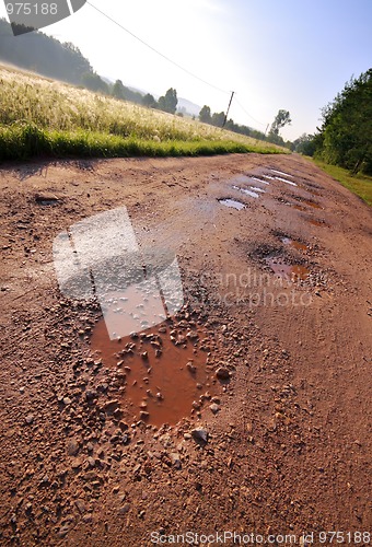 Image of Red clay road with holes