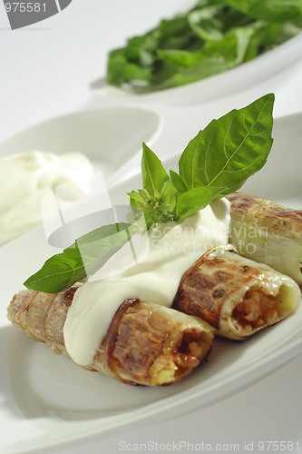 Image of Rolled pore's leaves with cream (creme fraiche) and basil 