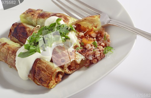 Image of Rolled pore's leaves with cream (creme fraiche) and basil