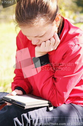 Image of Woman reading electronic book