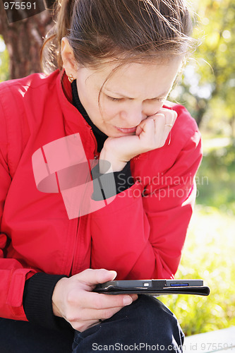 Image of Woman in red reading electronic book