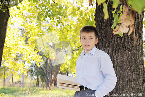 Image of Boy with book looking sideways