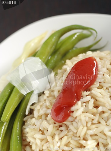 Image of Bean's pods and rice with red dressing