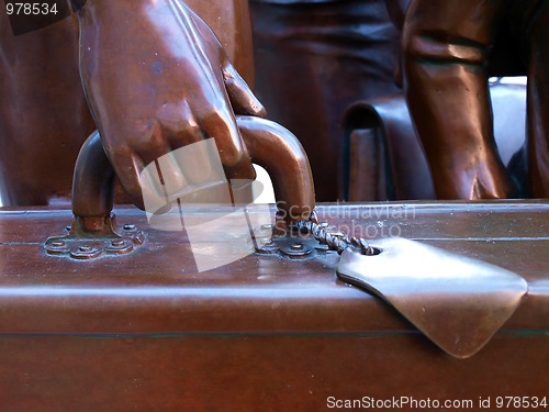 Image of Hand at the suit-case