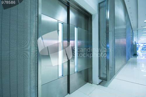 Image of  big steel door in office building with long corridor 