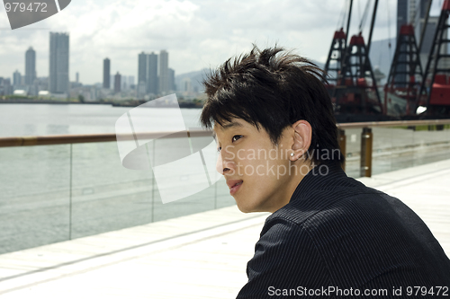 Image of asia man relax in the park in the city
