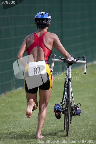 Image of Triathlete pushing his bike 