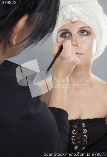 Image of Woman having her makeup applied 