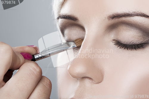 Image of Woman having her makeup applied