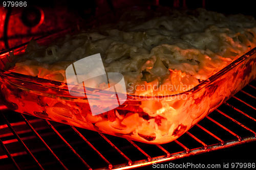 Image of lasagne in the owen still cooking . 