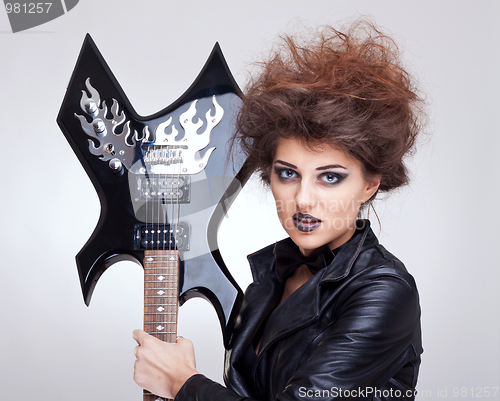 Image of woman holding an electric guitar