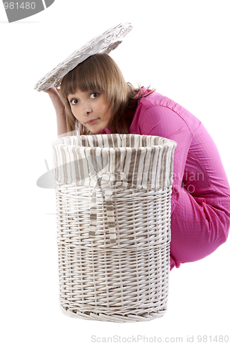 Image of Girl peers out for baskets for linen