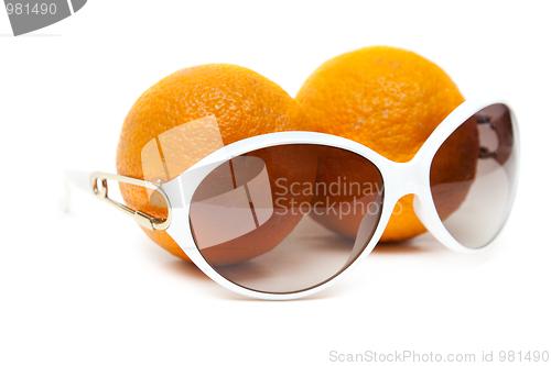 Image of Sunglasses and two oranges