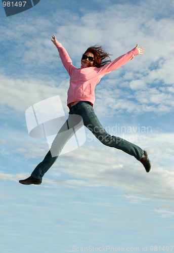 Image of Girl in jump on background sky