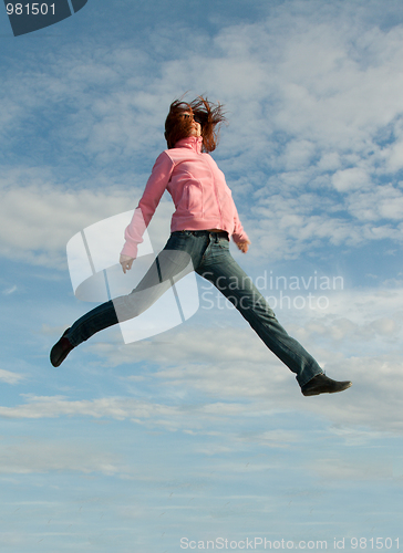 Image of Girl in jump on background sky