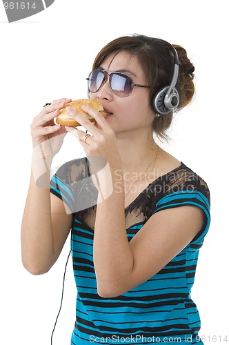 Image of  woman with hamburger, sunglasses and head phones