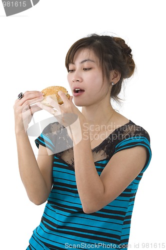 Image of young woman eating a hamburger