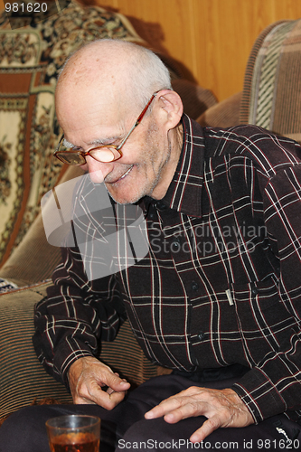 Image of Smiling senior man with tea