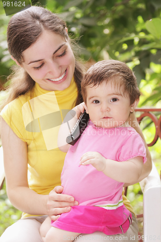 Image of Baby girl with phone receiver