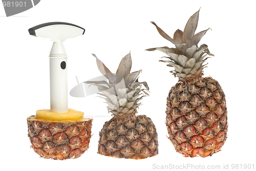 Image of Whole and split pineapple with cutter