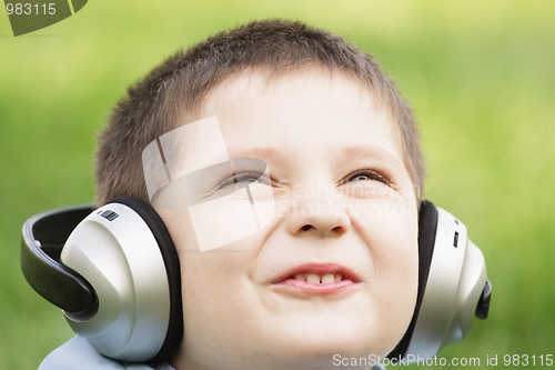 Image of Smiling boy in headphones looking up
