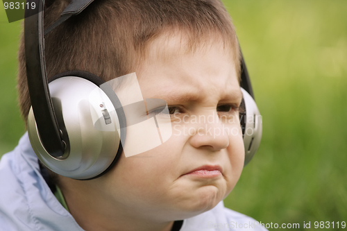 Image of Portrait of sceptic boy in headphones