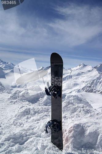 Image of Snowboard against the hight mountains