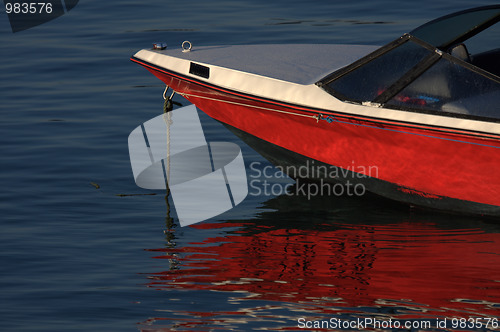 Image of tip of red and white speedboat