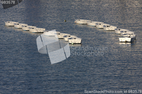 Image of two columns of white boats