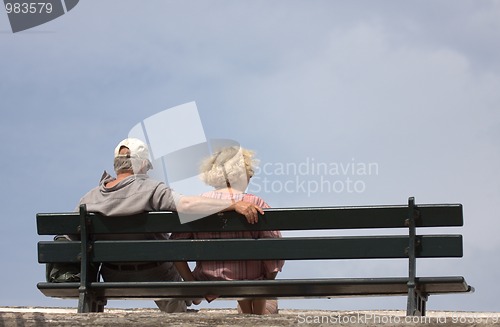 Image of an elderly couple sitting on a bench