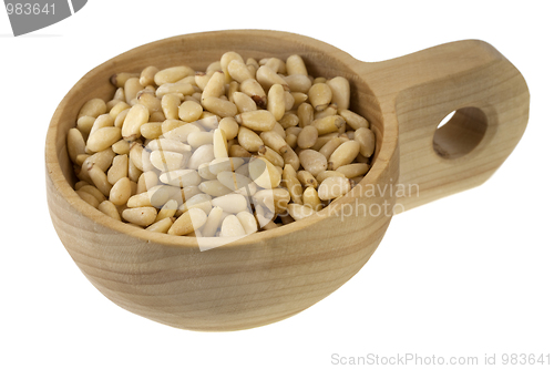 Image of scoop of pine nuts