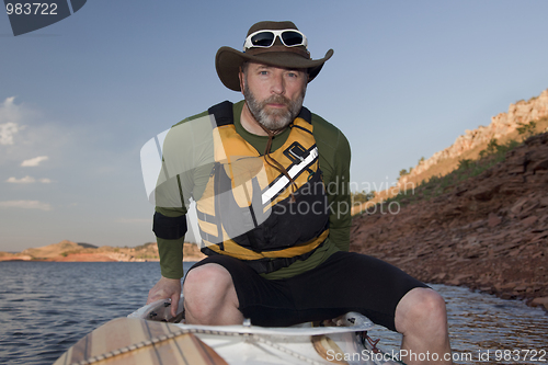 Image of paddler boarding his canoe