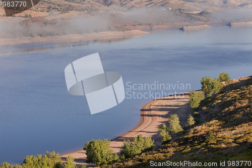 Image of foggy morning on mountain lake