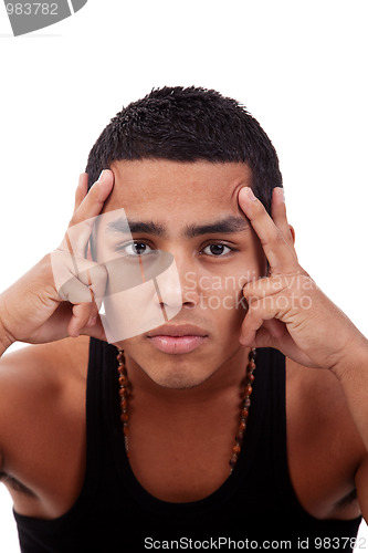 Image of young and handsome latin man, with hands holding the face 