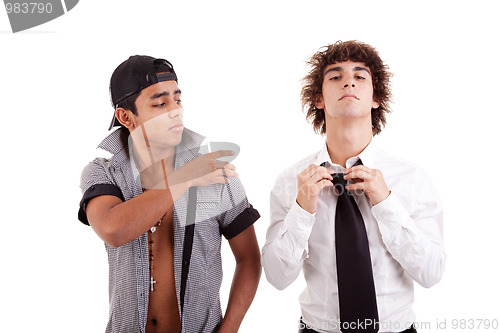 Image of young latin men, gesturing  with a finger - removing something from the shoulder (a white boy), 