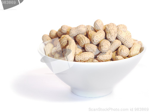 Image of White bowl with unshelled peanuts