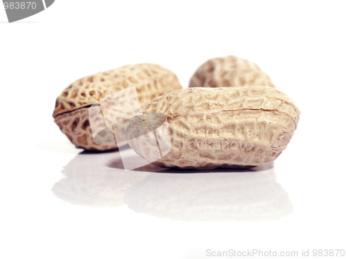 Image of Three unshelled peanuts