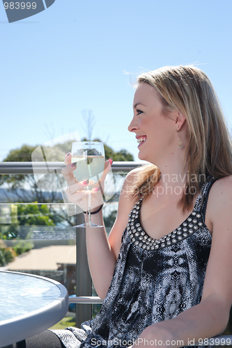 Image of young woman with glass of wine