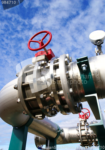 Image of Industrial zone, Steel pipelines and valves against blue sky