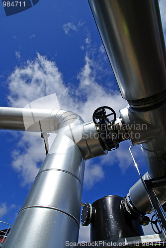 Image of Industrial zone, Steel pipelines and valves against blue sky